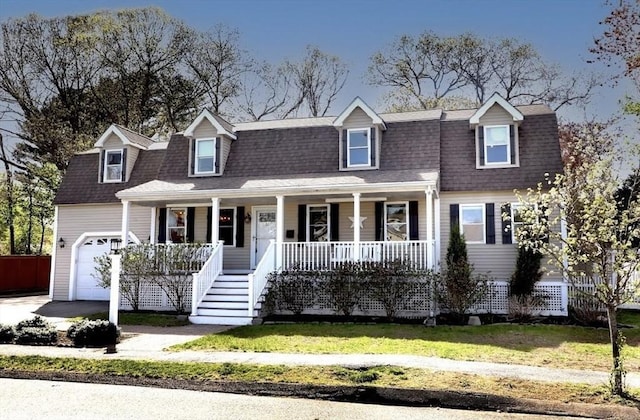 32 Nelson Ave, Beverly, MA 01915 - view of front facade featuring a front lawn, a shingled roof, covered porch, and a garage