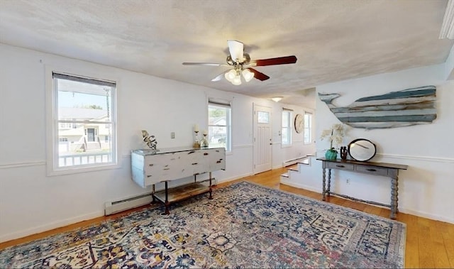 32 Nelson Ave, Beverly, MA 01915 - entrance foyer with wood finished floors, a ceiling fan, baseboards, a baseboard radiator, and stairs