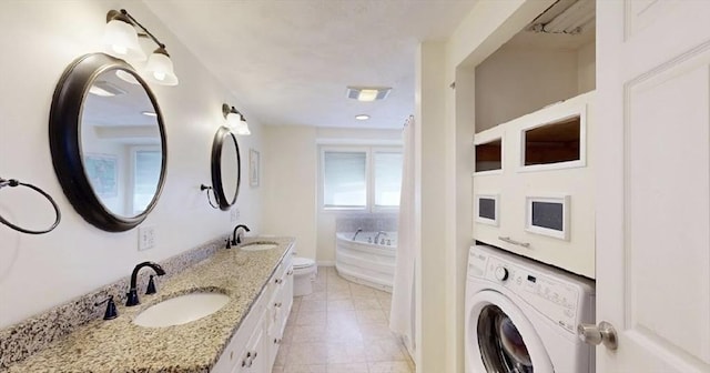 32 Nelson Ave, Beverly, MA 01915 - bathroom featuring a garden tub, visible vents, a sink, and double vanity