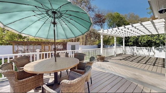 32 Nelson Ave, Beverly, MA 01915 - wooden deck with a pergola, outdoor dining area, an outdoor structure, a fenced backyard, and a shed