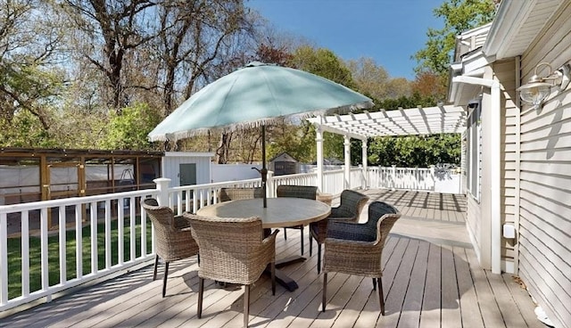 32 Nelson Ave, Beverly, MA 01915 - wooden terrace with a storage shed, a pergola, outdoor dining area, a fenced backyard, and an outbuilding
