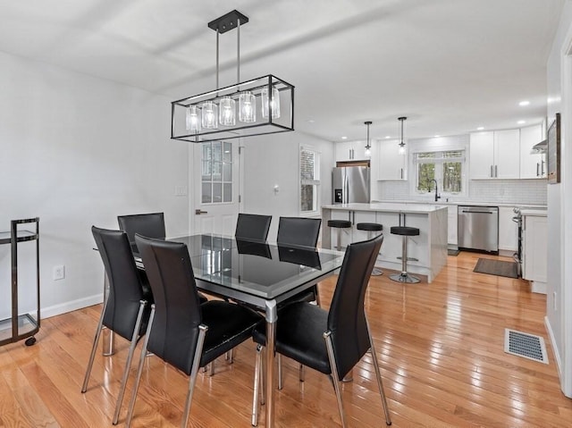 dining room with visible vents, recessed lighting, light wood finished floors, and baseboards
