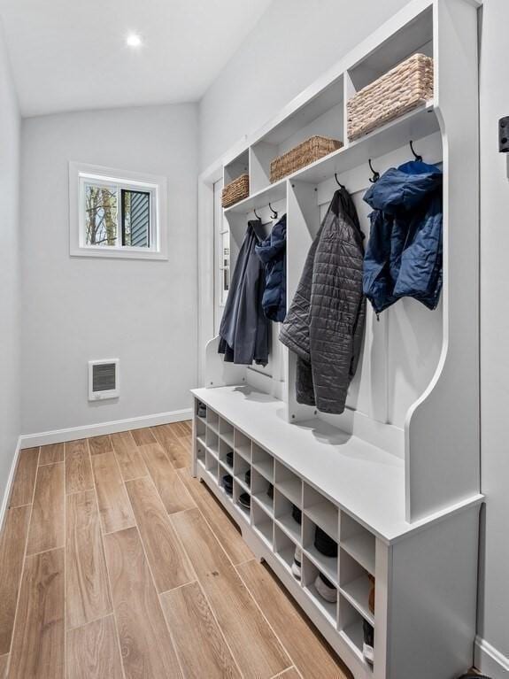 mudroom with light wood finished floors, recessed lighting, baseboards, lofted ceiling, and visible vents