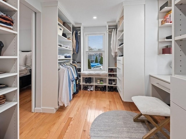 walk in closet with light wood-type flooring