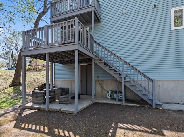 exterior space with an outdoor hangout area, stairs, a deck, and a balcony