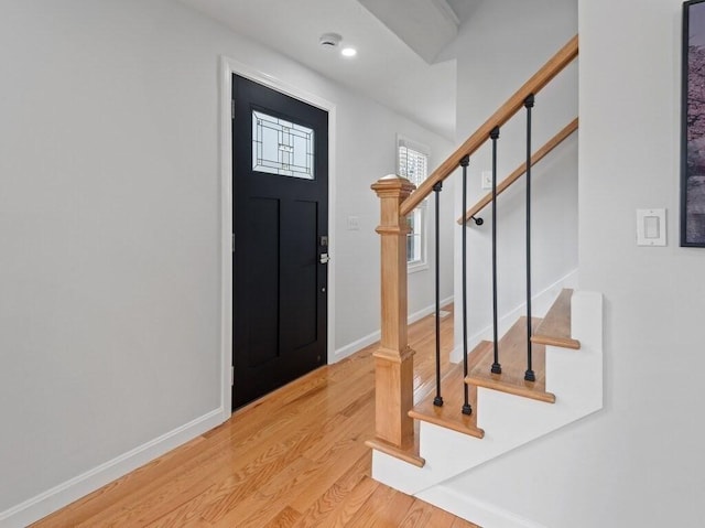 entrance foyer featuring baseboards, recessed lighting, wood finished floors, and stairway
