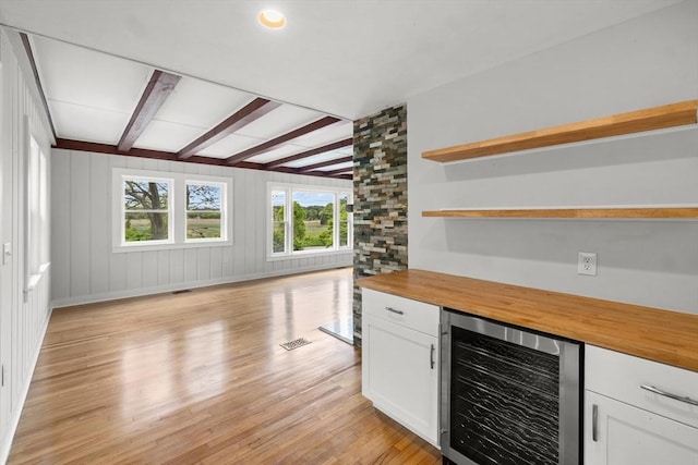 67 Great Neck Rd, Wareham, MA 02571 - indoor dry bar featuring beverage cooler, light wood-style floors, beamed ceiling, and baseboards