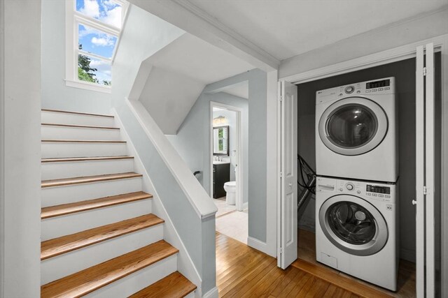 67 Great Neck Rd, Wareham, MA 02571 - laundry area with stacked washer / drying machine, wood-type flooring, plenty of natural light, and baseboards