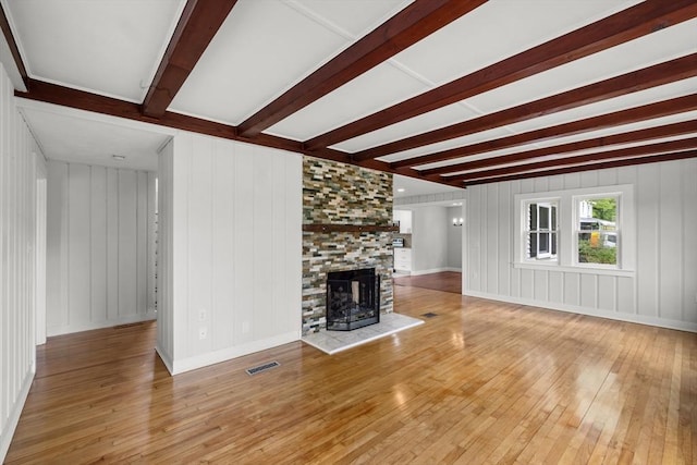 67 Great Neck Rd, Wareham, MA 02571 - unfurnished living room featuring hardwood / wood-style floors, beamed ceiling, a multi sided fireplace, and baseboards