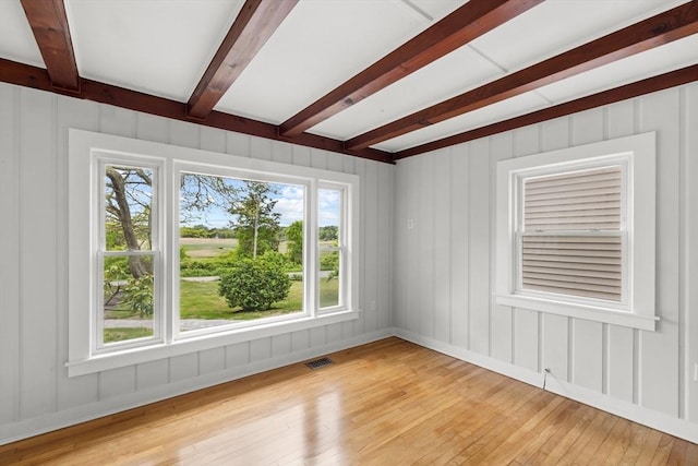 67 Great Neck Rd, Wareham, MA 02571 - empty room with beamed ceiling, light wood-style flooring, and a decorative wall