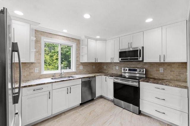 67 Great Neck Rd, Wareham, MA 02571 - kitchen featuring stainless steel appliances, a sink, white cabinetry, backsplash, and light stone countertops