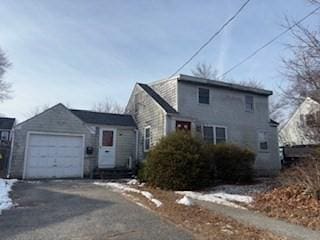 view of snowy exterior featuring a garage