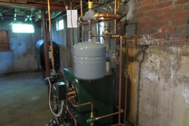 utility room featuring oil tank and a heating unit