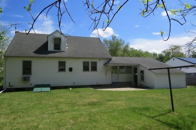 rear view of property with a yard, a patio, and a shingled roof
