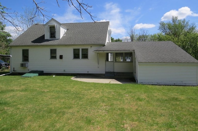 back of house featuring a patio area, a lawn, and a shingled roof