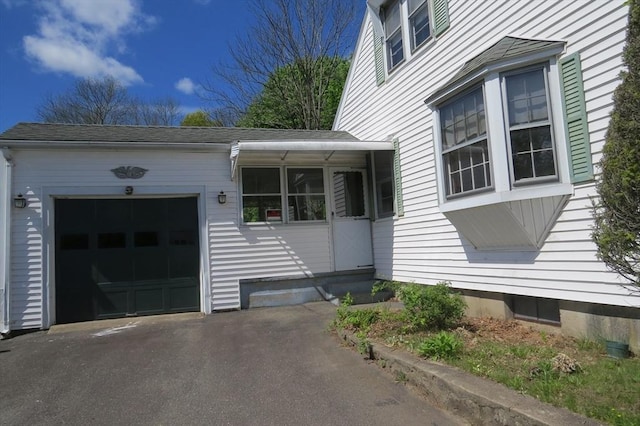 view of side of property with a garage and driveway