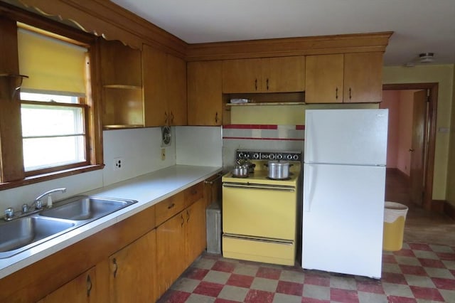 kitchen featuring white appliances, light flooring, light countertops, and range hood