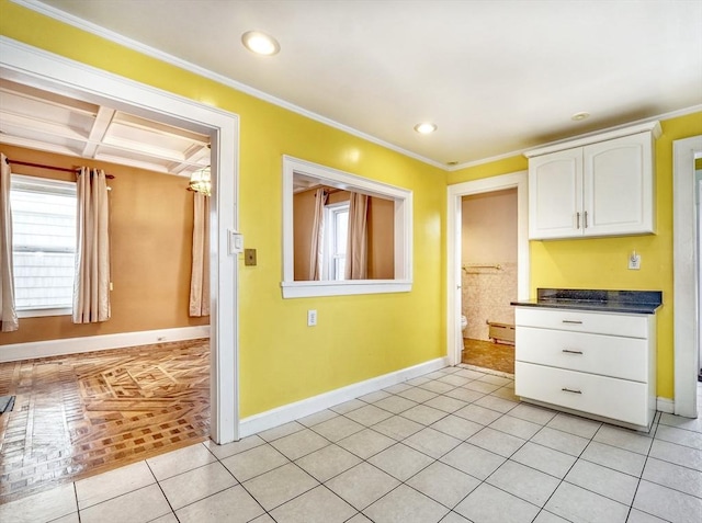 10 Windom St, Boston, MA 02134 - kitchen with baseboards, ornamental molding, light tile patterned floors, white cabinetry, and dark countertops