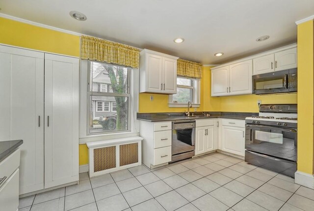 10 Windom St, Boston, MA 02134 - kitchen featuring black microwave, dark countertops, gas range, dishwasher, and a sink