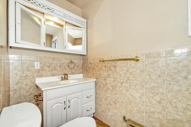 10 Windom St, Boston, MA 02134 - bathroom featuring tile walls, toilet, vanity, and a wainscoted wall
