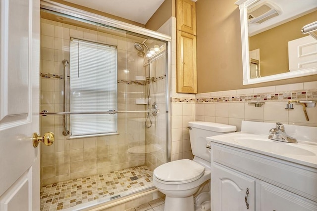 10 Windom St, Boston, MA 02134 - bathroom featuring visible vents, toilet, tile walls, a shower stall, and vanity