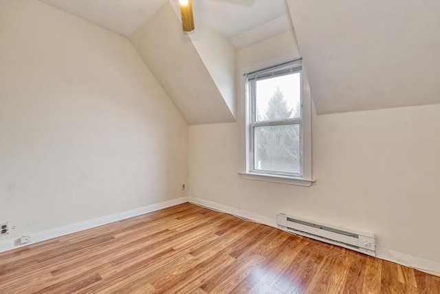 10 Windom St, Boston, MA 02134 - additional living space featuring a baseboard radiator, vaulted ceiling, wood finished floors, and baseboards