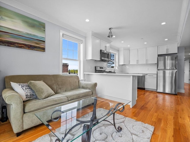 living room featuring light wood-style floors and recessed lighting