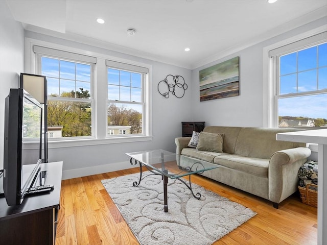 living room featuring recessed lighting, baseboards, and light wood finished floors