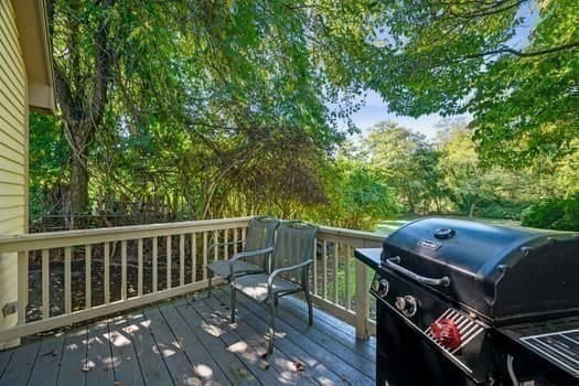 wooden terrace featuring a grill