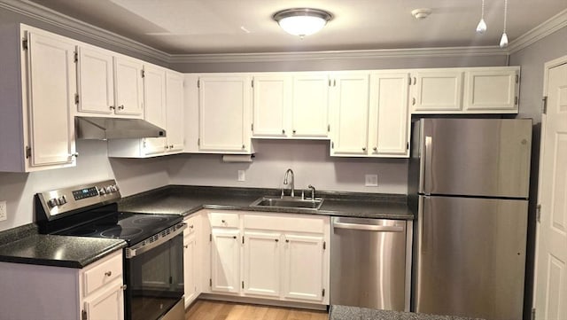 56 Edgeworth St Unit 14, Worcester, MA 01605 - kitchen with appliances with stainless steel finishes, under cabinet range hood, dark countertops, crown molding, and light wood-type flooring