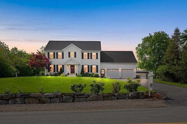 172 Orchard St, Newbury, MA 01922 - colonial-style house with a garage, asphalt driveway, and a front yard