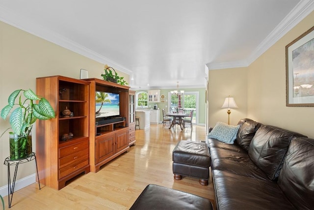 172 Orchard St, Newbury, MA 01922 - living area featuring light wood finished floors, ornamental molding, a chandelier, and baseboards