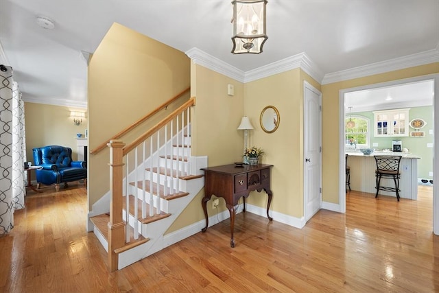 172 Orchard St, Newbury, MA 01922 - foyer entrance featuring stairs, light wood finished floors, ornamental molding, and baseboards