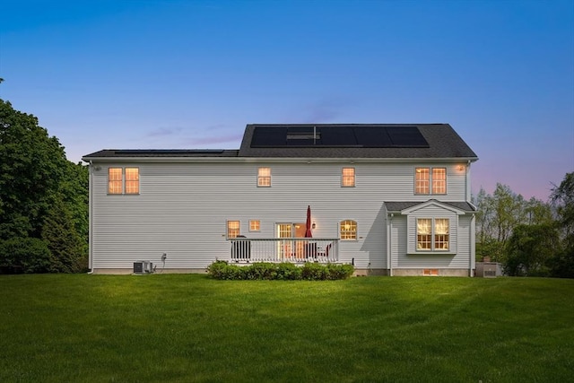 172 Orchard St, Newbury, MA 01922 - rear view of house with a yard, central AC, and roof mounted solar panels