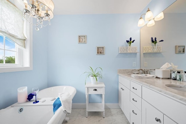 172 Orchard St, Newbury, MA 01922 - bathroom with marble look tiles, baseboards, double vanity, a soaking tub, and a chandelier