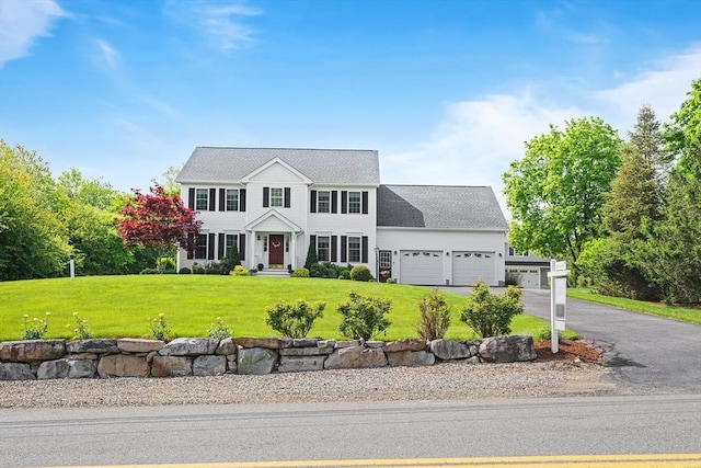 172 Orchard St, Newbury, MA 01922 - colonial-style house featuring an attached garage, a front yard, and driveway