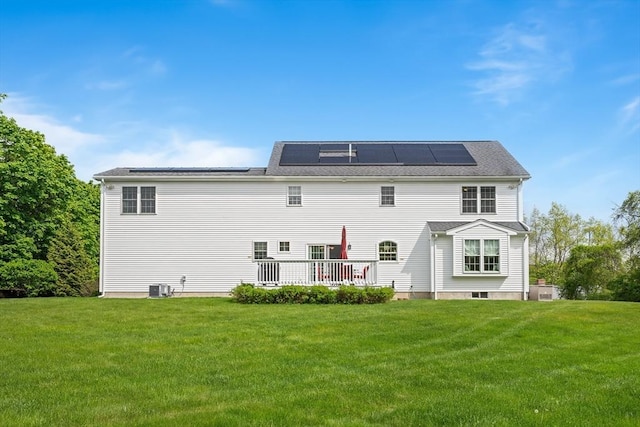 172 Orchard St, Newbury, MA 01922 - rear view of house with cooling unit, a yard, solar panels, and a wooden deck