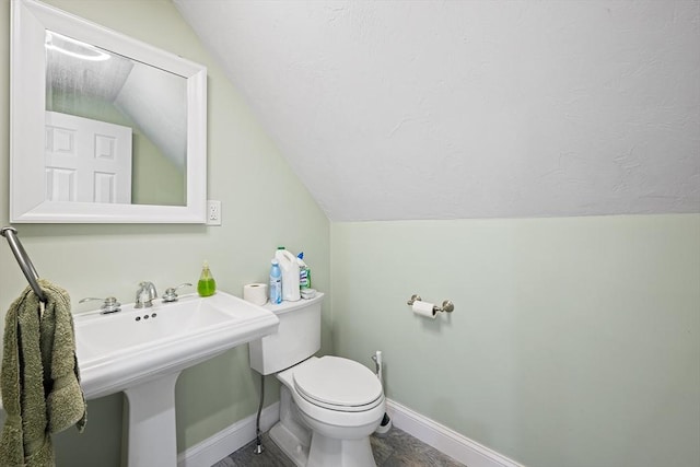 172 Orchard St, Newbury, MA 01922 - bathroom featuring vaulted ceiling, toilet, baseboards, and a sink
