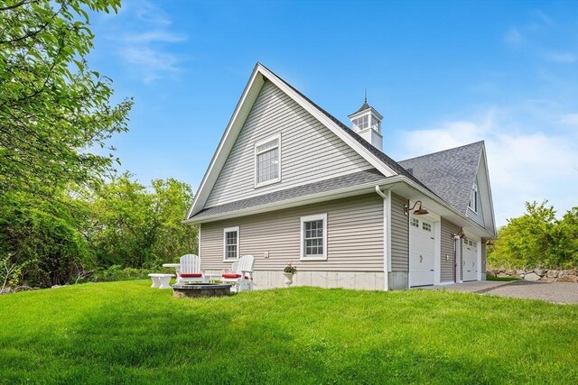 172 Orchard St, Newbury, MA 01922 - view of side of home featuring a lawn, a shingled roof, asphalt driveway, and an attached garage