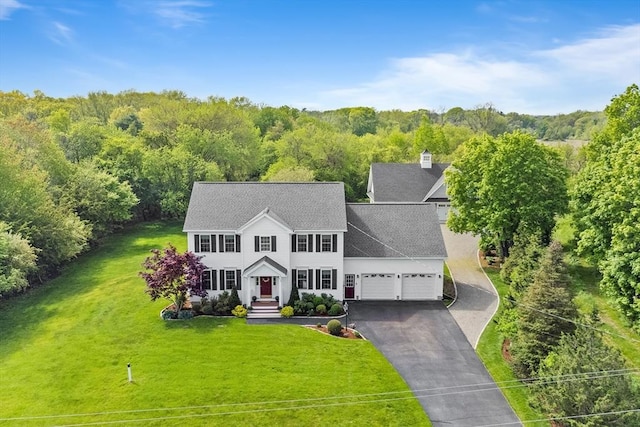 172 Orchard St, Newbury, MA 01922 - view of front facade with a garage, driveway, a front yard, a forest view, and a shingled roof