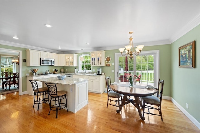 172 Orchard St, Newbury, MA 01922 - kitchen featuring a chandelier, stainless steel microwave, a sink, a kitchen island, and ornamental molding