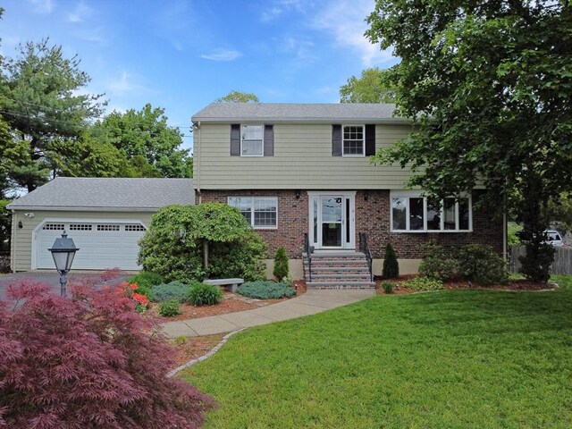 10 Emile Cir, Medford, MA 02155 - colonial home featuring an attached garage, a front lawn, and brick siding