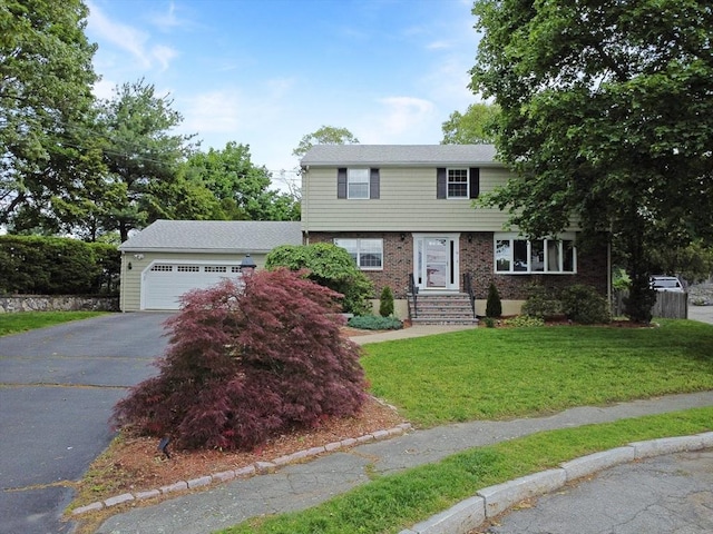 10 Emile Cir, Medford, MA 02155 - colonial house featuring driveway, a garage, a front yard, and brick siding
