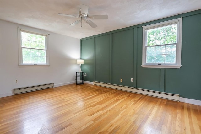 10 Emile Cir, Medford, MA 02155 - empty room with a baseboard heating unit, wood finished floors, ceiling fan, and baseboards