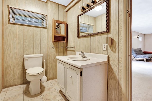 10 Emile Cir, Medford, MA 02155 - bathroom featuring vanity, toilet, wooden walls, and tile patterned floors