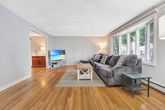 10 Emile Cir, Medford, MA 02155 - living room featuring light wood finished floors, baseboards, and baseboard heating
