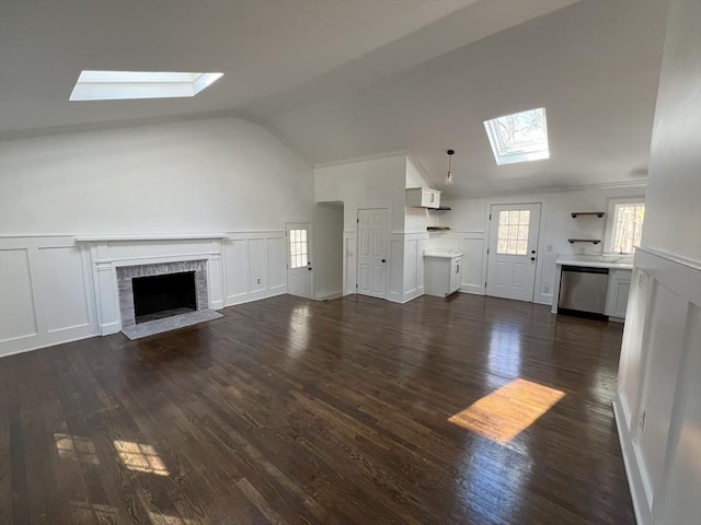 512 Lincoln St, Duxbury, MA 02332 - unfurnished living room with a skylight, a decorative wall, lofted ceiling, a fireplace, and dark wood-style flooring