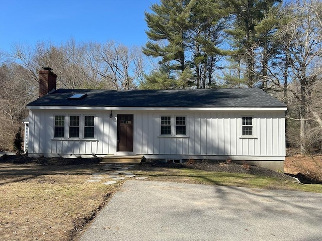 512 Lincoln St, Duxbury, MA 02332 - view of front of house featuring board and batten siding, a shingled roof, and a chimney