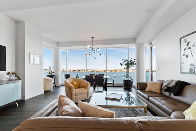 living room featuring a chandelier, wood-type flooring, and a water view