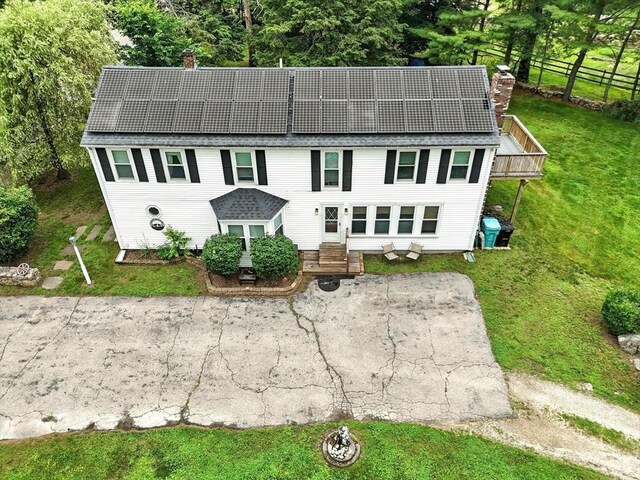 23 Westboro Rd, Upton, MA 01568 - view of front of home with a chimney and roof mounted solar panels